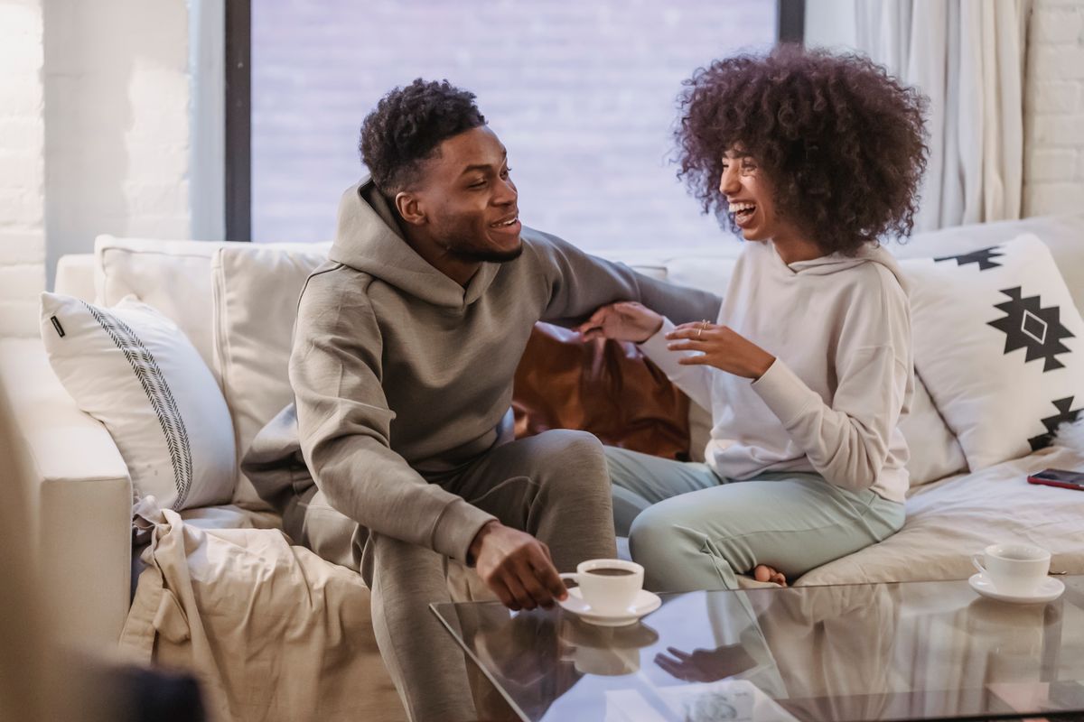Couple talking together on a sofa