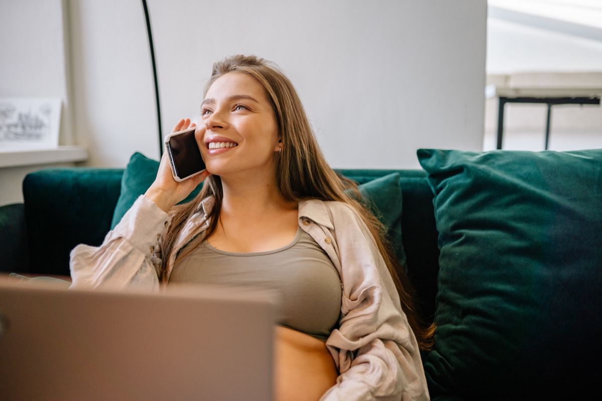 Woman smiling on the phone at home